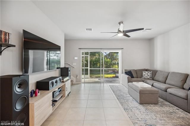 living room with light tile patterned floors and ceiling fan