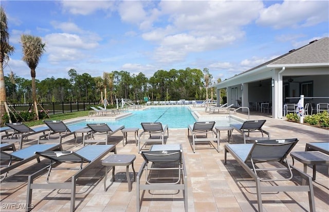 view of pool with a patio and ceiling fan