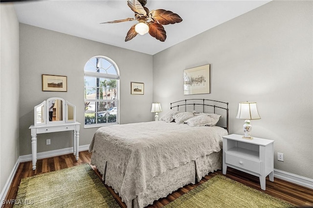 bedroom with dark hardwood / wood-style floors and ceiling fan