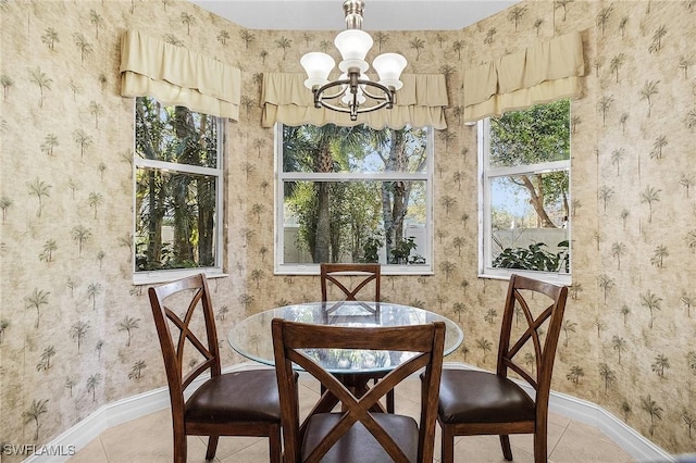 dining area with tile patterned flooring and an inviting chandelier