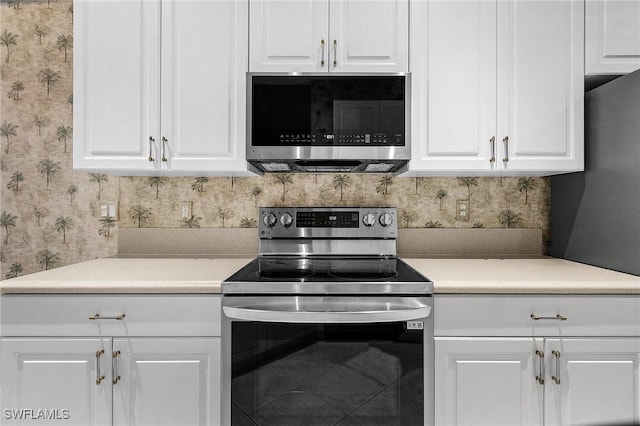 kitchen featuring white cabinetry, backsplash, and stainless steel appliances