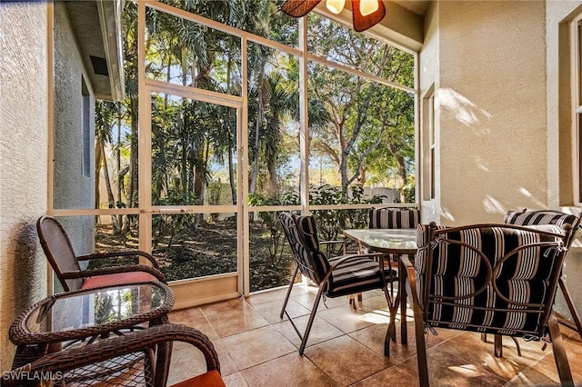 sunroom / solarium featuring ceiling fan and a wealth of natural light