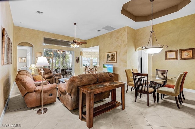 tiled living room with ceiling fan