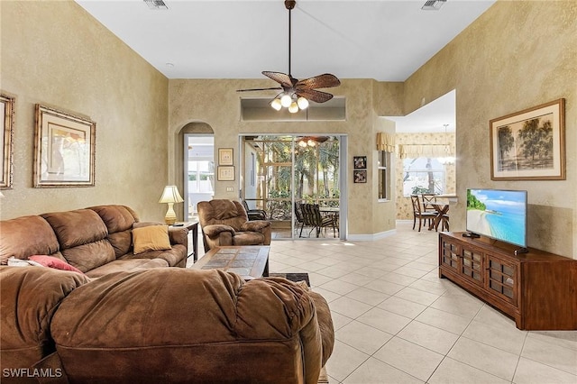 tiled living room with ceiling fan