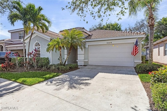 mediterranean / spanish-style house with a garage