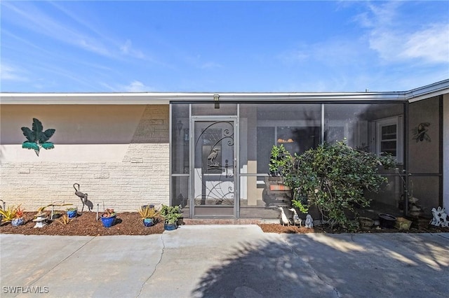 entrance to property with a patio