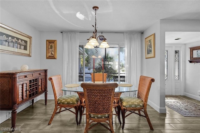 dining room with dark hardwood / wood-style floors and a textured ceiling