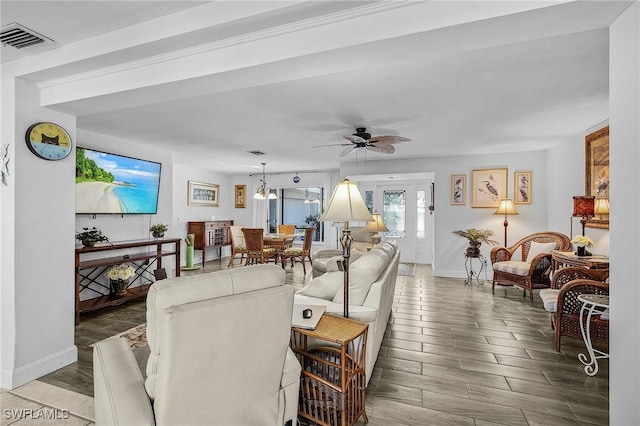 living room featuring hardwood / wood-style floors and ceiling fan with notable chandelier