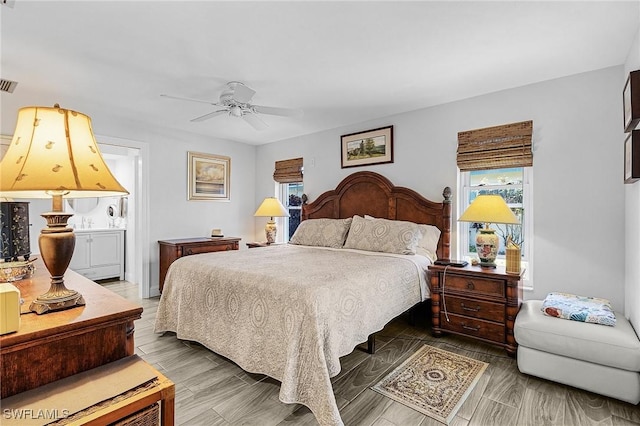 bedroom with ensuite bath and ceiling fan