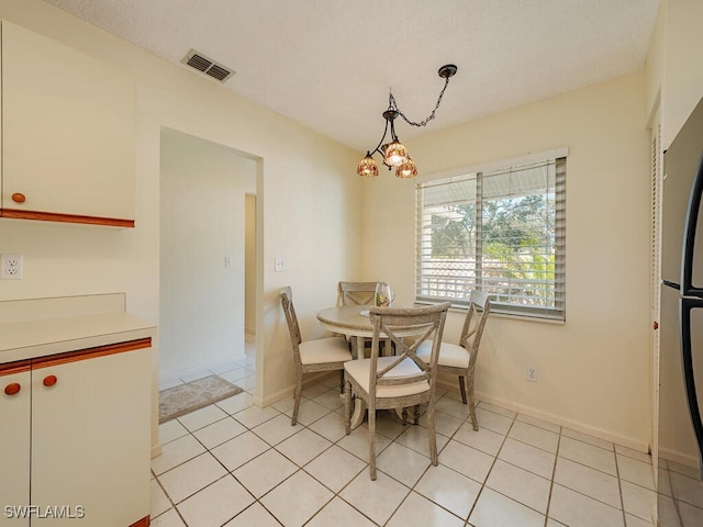 tiled dining area with a notable chandelier