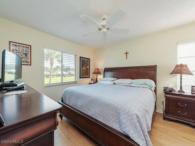 bedroom featuring ceiling fan and light hardwood / wood-style floors