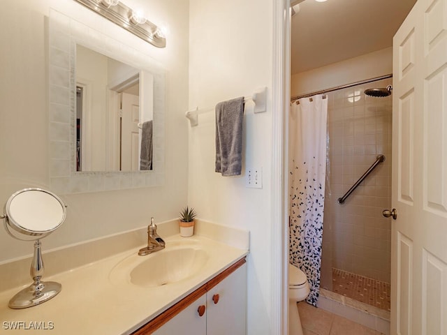 bathroom with tile patterned floors, vanity, toilet, and curtained shower