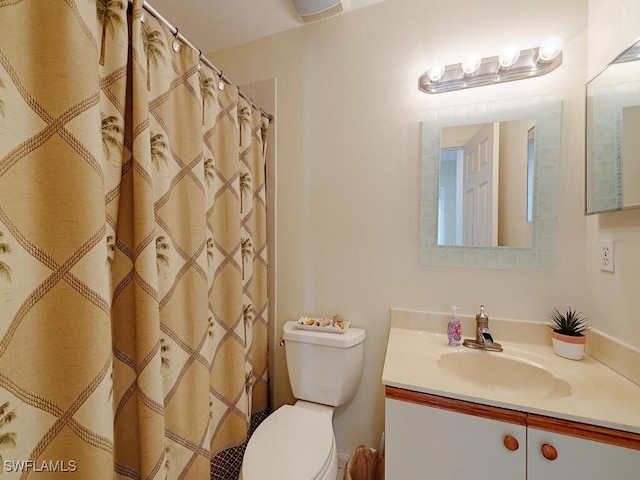 bathroom featuring vanity, curtained shower, and toilet