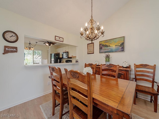 dining room featuring lofted ceiling, light hardwood / wood-style floors, and ceiling fan