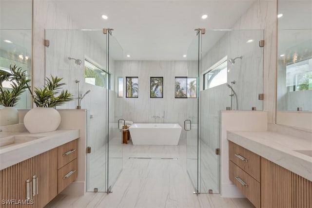 bathroom with vanity, shower with separate bathtub, and tile walls