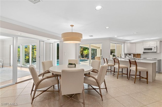 dining room featuring light tile patterned flooring and ornamental molding