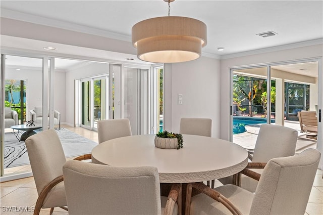 dining room with ornamental molding, a wealth of natural light, and light tile patterned floors