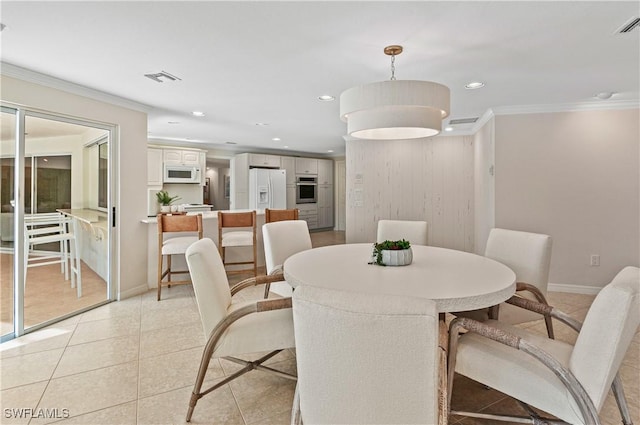 dining room with crown molding and light tile patterned flooring