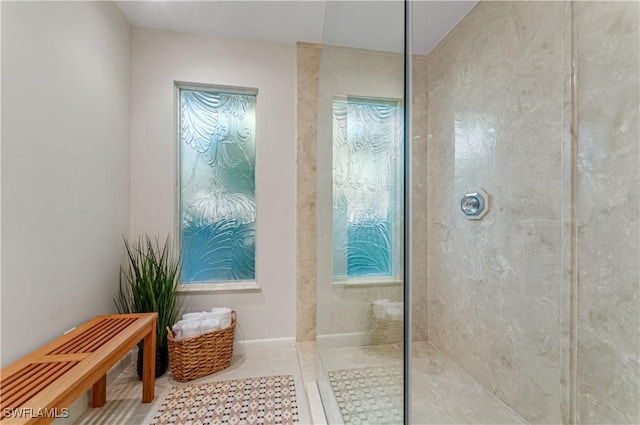 bathroom with tile patterned floors and a tile shower