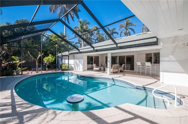 view of swimming pool featuring a patio area and glass enclosure