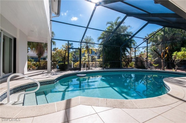 view of swimming pool featuring a patio and glass enclosure