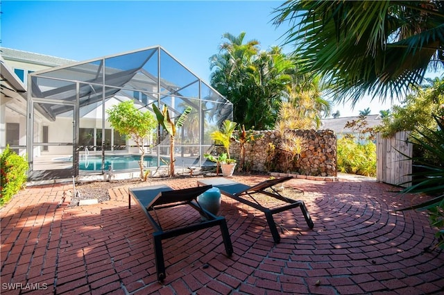 view of patio featuring glass enclosure