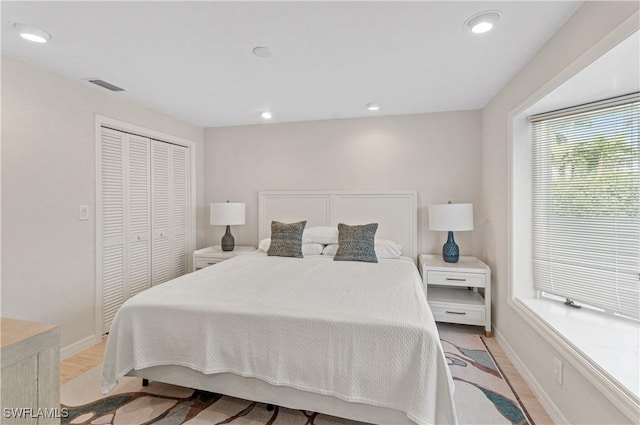 bedroom featuring a closet and light wood-type flooring