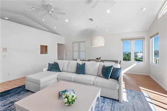 living room featuring lofted ceiling, hardwood / wood-style floors, and ceiling fan