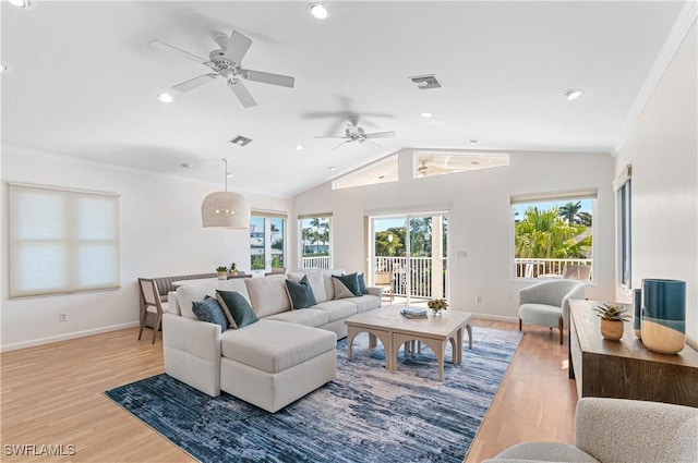 living room with crown molding, vaulted ceiling, and light wood-type flooring