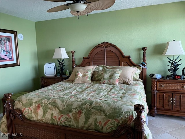 bedroom with light tile patterned floors, a textured ceiling, and ceiling fan