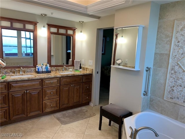 bathroom featuring tile patterned flooring, vanity, and a washtub