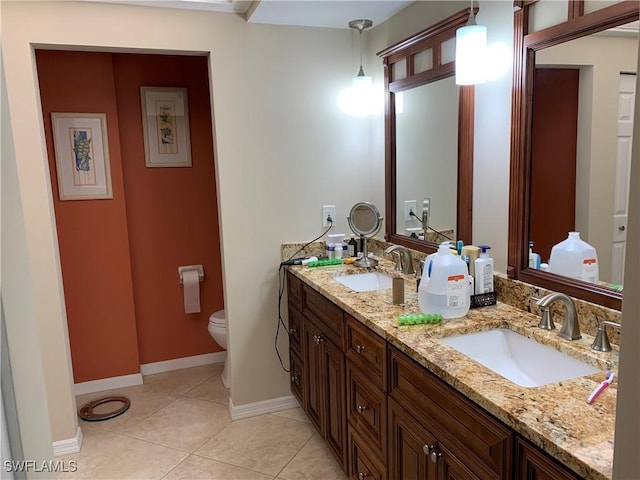 bathroom with tile patterned flooring, vanity, and toilet