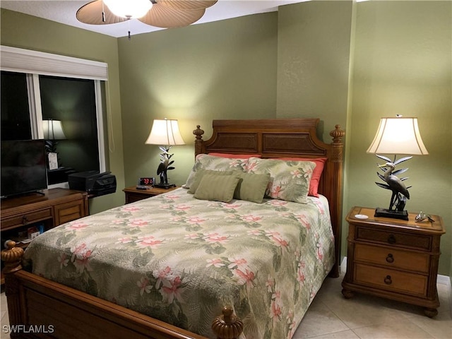 tiled bedroom with ceiling fan