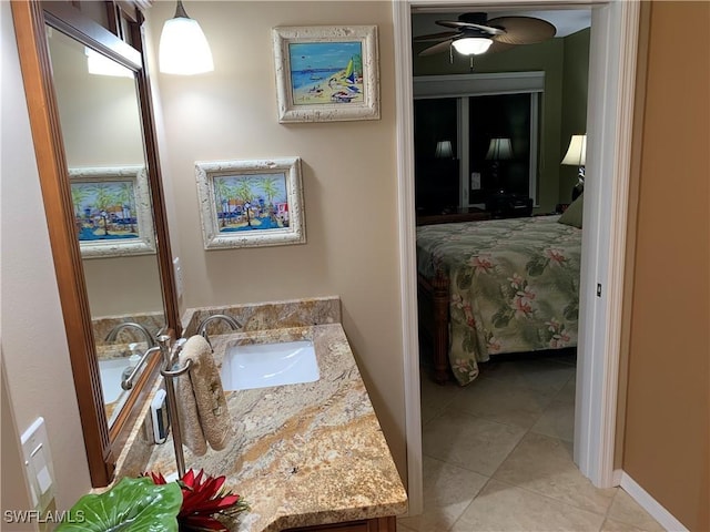 bathroom with tile patterned floors, a ceiling fan, and vanity