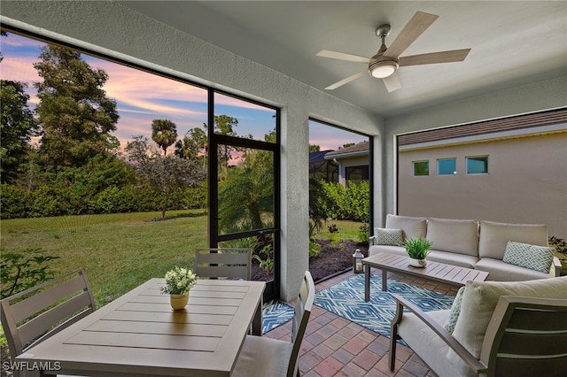 sunroom / solarium featuring ceiling fan