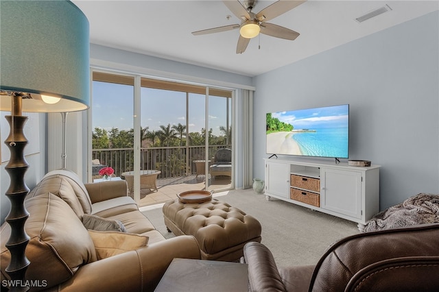 living room with ceiling fan and light colored carpet