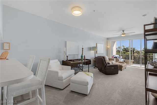 carpeted living room with ceiling fan