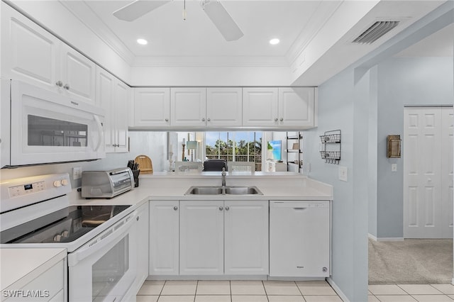 kitchen featuring light tile patterned flooring, white cabinetry, sink, ornamental molding, and white appliances