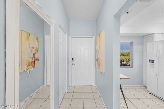 hall with light tile patterned floors