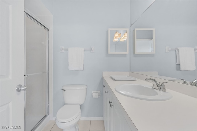 bathroom featuring vanity, tile patterned floors, toilet, and walk in shower