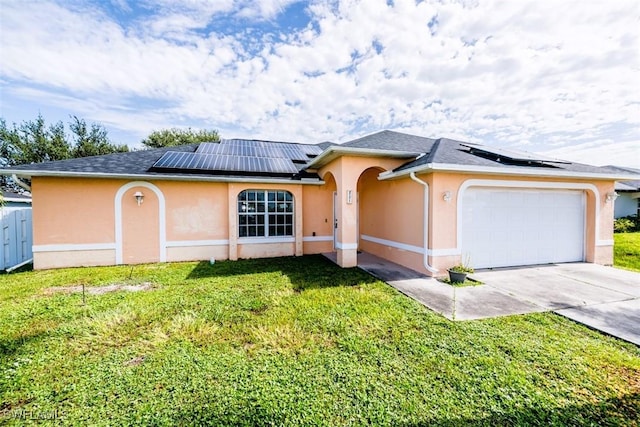 single story home featuring a garage, a front yard, and solar panels