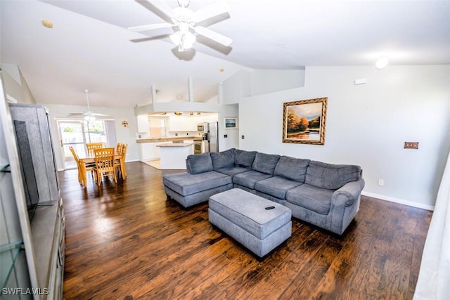 living room featuring ceiling fan, dark hardwood / wood-style flooring, and vaulted ceiling