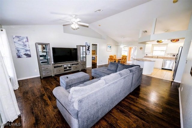 living room with dark wood-type flooring, vaulted ceiling, and ceiling fan