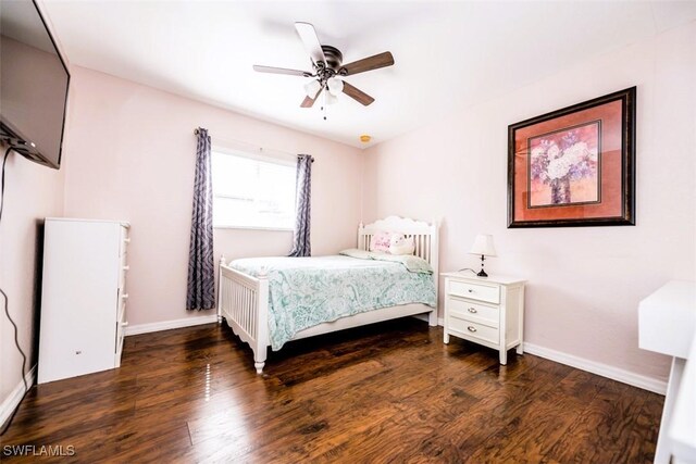 bedroom with dark hardwood / wood-style flooring and ceiling fan