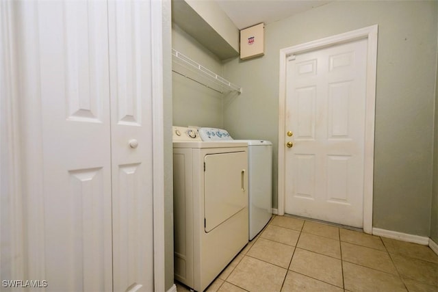 501 NE 24th Ter, Cape Coral, FL 33909 - laundry area with washer and clothes dryer and light tile patterned flooring