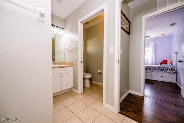 bathroom with tile patterned floors, vanity, and toilet