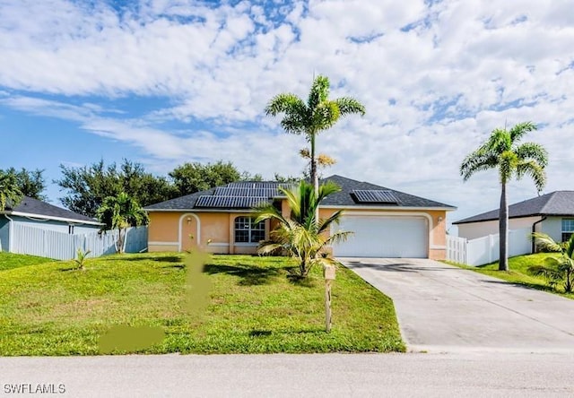 501 NE 24th Ter, Cape Coral, FL 33909 - ranch-style home with a garage, a front yard, and solar panels