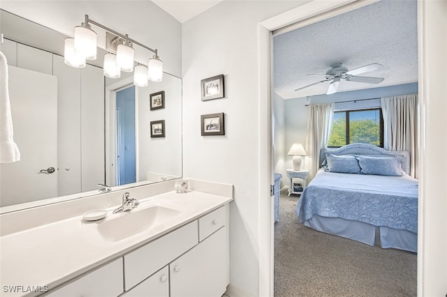 bathroom with vanity, a textured ceiling, and ceiling fan