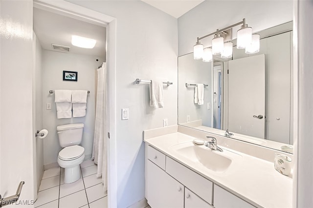 bathroom featuring tile patterned flooring, vanity, and toilet