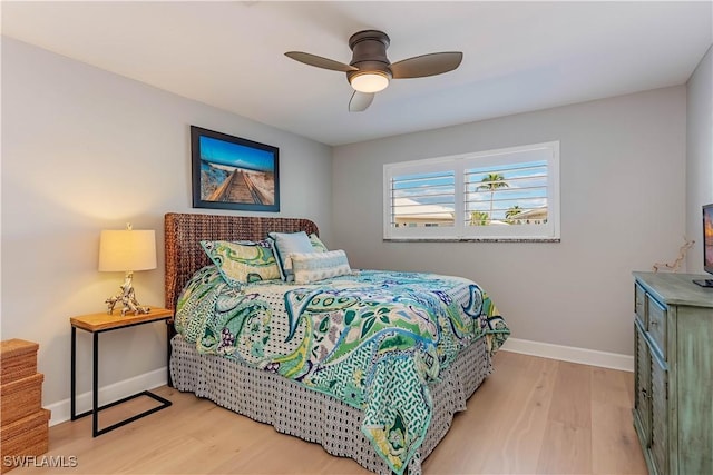 bedroom with ceiling fan and light hardwood / wood-style floors